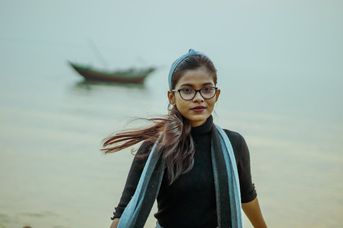 Indian girl standing on shore